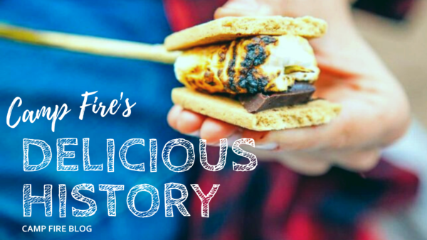 Camp Fire's Delicious History image of roasted marshmallow on stick between graham crackers