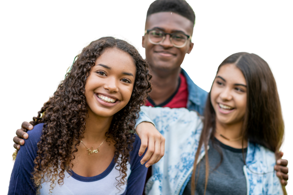 Three teens smiling and leaning on each other