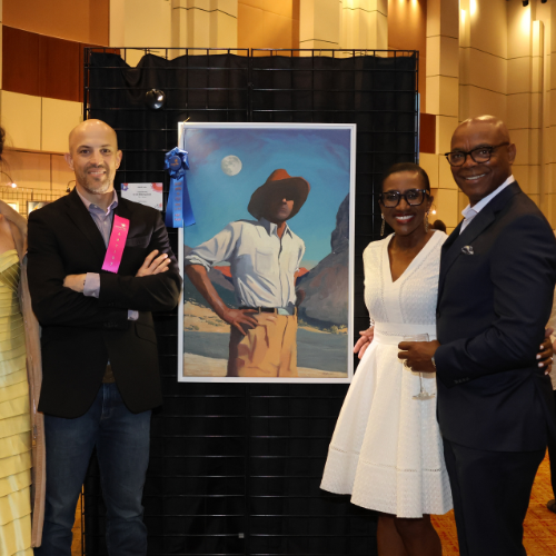 Photo of artist and winning bidders with artwork